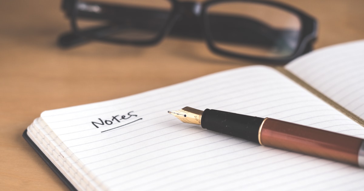 Handwritten journaling on scrapbook pages with prompts