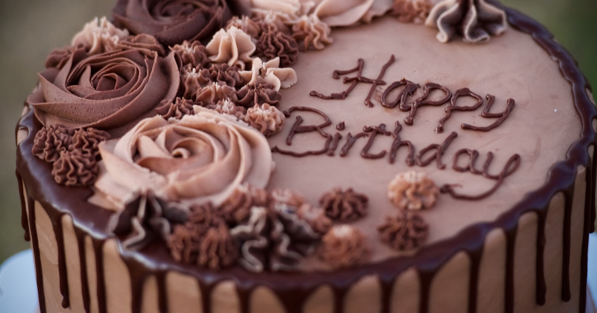 Camera beside printed photographs arranged on a craft table